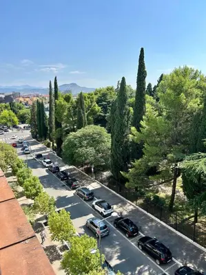 a line of cars parked in a parking lot at Central Park Apartment in Podgorica