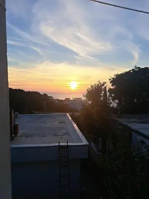 a view of the sunset from the roof of a house at Apartman Marinamar in Utjeha