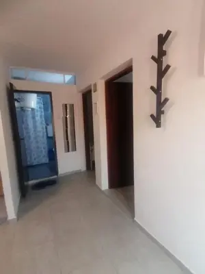 an empty room with a door and a cross on the wall at Apartman Marinamar in Utjeha