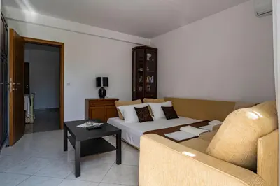 a living room with a bed and a couch at Guesthouse Drašković in Petrovac na Moru