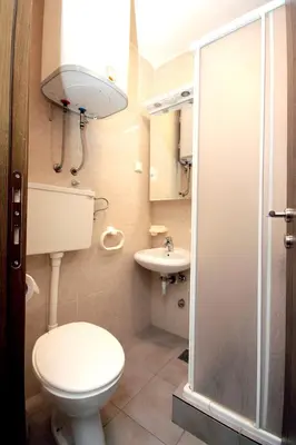 a bathroom with a toilet and a sink at Guesthouse Drašković in Petrovac na Moru