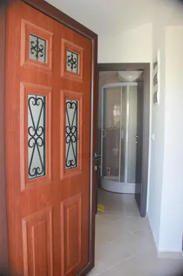 a wooden door in a room with a hallway at Apartments Aneta in Ulcinj