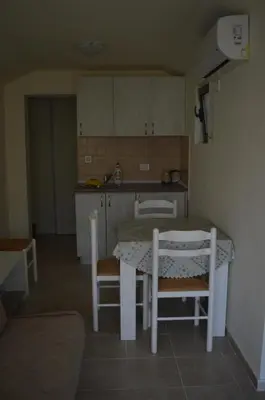 a kitchen with a table and chairs in a room at Apartments Aneta in Ulcinj