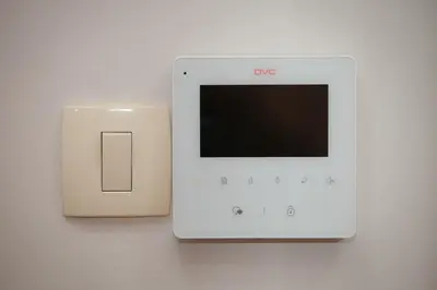 a white ipod is hooked up to a lightswitch at City Nest apartment in Podgorica