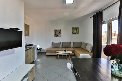 a living room with a couch and a table at Apartmani BLUE MOON in Dobra Voda