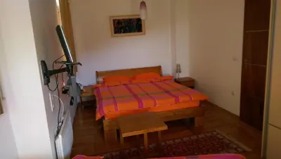 a bedroom with a bed with orange pillows on it at Holiday House Villa Neda in Utjeha