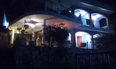 a building at night with lights on at Holiday House Villa Neda in Utjeha