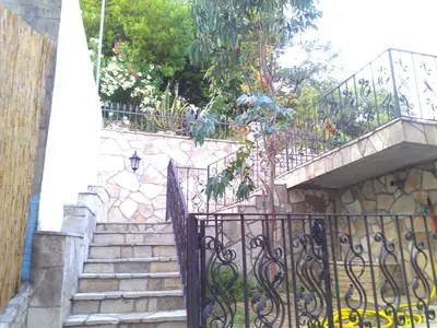 a staircase with a wrought iron gate next to a building at Holiday House Villa Neda in Utjeha
