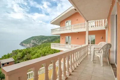 a balcony of a house with a view of the ocean at Snežna Kraljica in Sutomore
