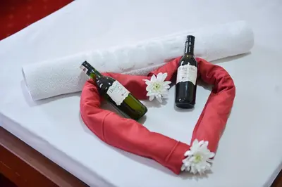 a table with two bottles of wine and flowers at Dolce Vita in Budva
