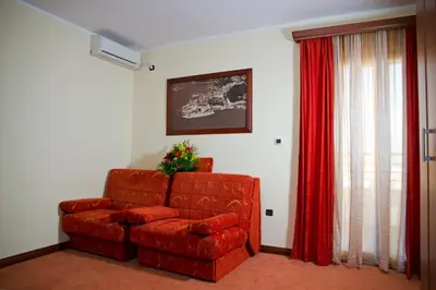 a living room with a red couch and red curtains at Dolce Vita in Budva
