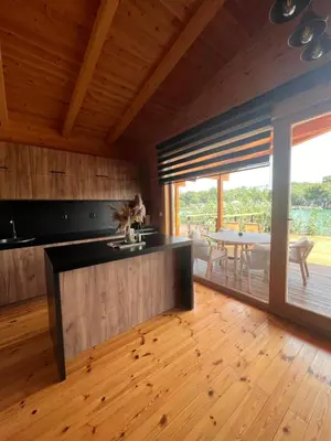 a kitchen with wooden floors and a wooden ceiling at GOLD FISH in Gornji Štoj