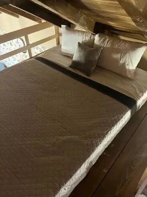 a large bed in a room with pillows at The Stonehouse in Ulcinj
