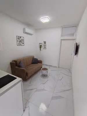 a living room with a couch and a table at lux apartmani Porte Nouva in Sutomore