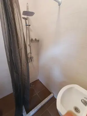 a bathroom with a shower and a toilet and a sink at lux apartmani Porte Nouva in Sutomore