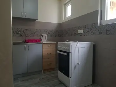 a kitchen with a white stove and a refrigerator at Apartment Danijela in Budva