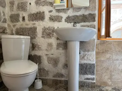 a bathroom with a toilet and a sink at South Gate apartments 262 in Kotor