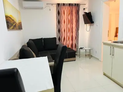 a living room with a couch and a table at Apartments MyDay in Budva