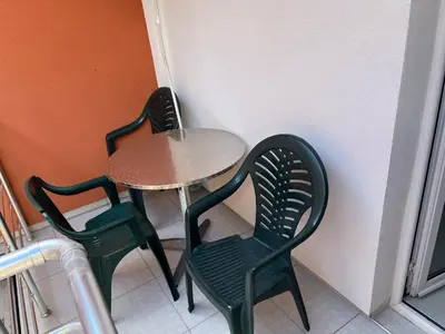a small table and two chairs next to a small table and chairs at Apartments MyDay in Budva