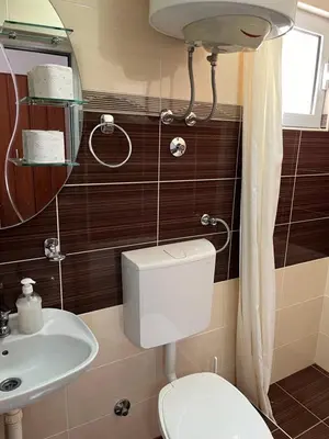 a bathroom with a toilet and a sink at Apartments MyDay in Budva