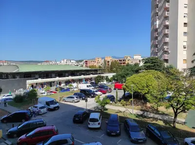 a parking lot with cars parked in a city at Central Station Apartment Podgorica in Podgorica