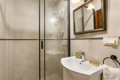 a bathroom with a sink and a shower at Apartments Leo in Kotor