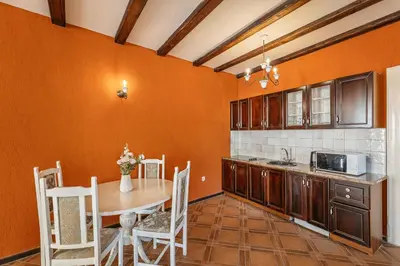 a kitchen with a table and a table and chairs at Apartments Leo in Kotor