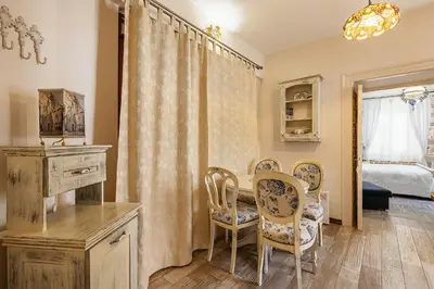 a room with a table and chairs and a bedroom at Apartments Leo in Kotor