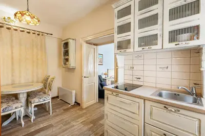 a kitchen with a sink and a table at Apartments Leo in Kotor