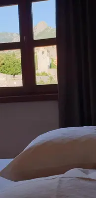 a bedroom with a bed and a window with a view at Apartment Old Town Stari Bar in Bar