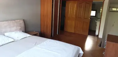 a bedroom with a white bed and a wooden door at Apartment Old Town Stari Bar in Bar