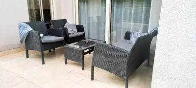 a patio with two chairs and a table and a chair at Budva Morska oaza in Budva