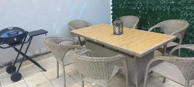 a wooden table with chairs and a candle on it at Budva Morska oaza in Budva