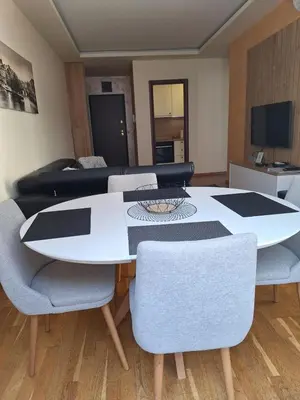a living room with a table and chairs and a couch at Budva Morska oaza in Budva