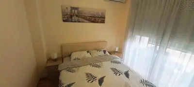 a bedroom with a bed and a window at Budva Morska oaza in Budva