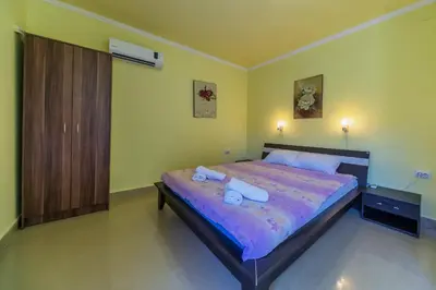 a bedroom with a bed with two towels on it at Villa Tivat in Tivat