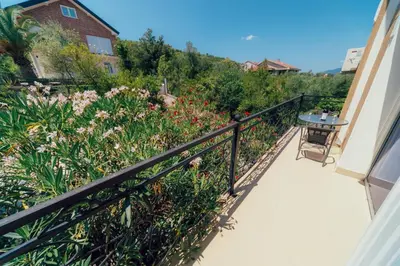 a balcony with a view of a garden with flowers at Villa Tivat in Tivat