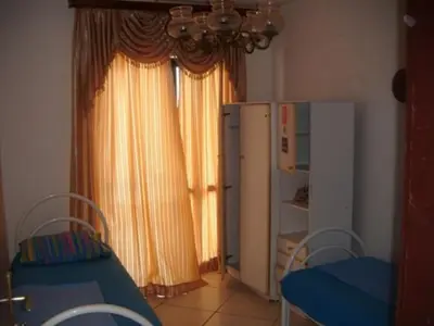 a room with a refrigerator and a table and chairs at Apartments Pekic in Bar