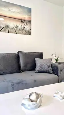 a living room with a couch and a ball on a table at Apartman DolceRosa in Kotor