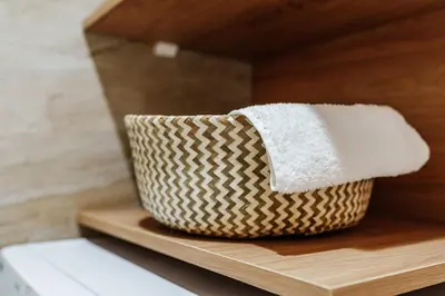 a basket of towels sitting on a wooden shelf at Skyline Apartments by In Property in Becici