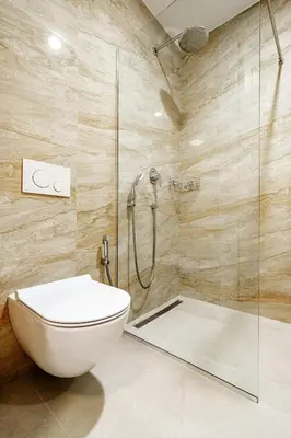 a bathroom with a toilet and a glass shower at Skyline Apartments by In Property in Becici