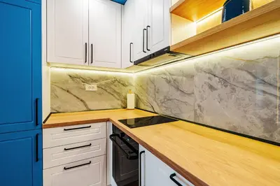 a kitchen with white cabinets and a counter top at Skyline Apartments by In Property in Becici