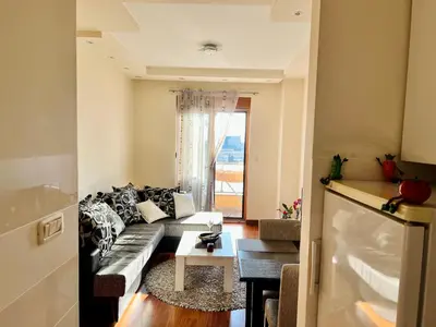 a living room with a couch and a table at Urban Suite Athos in Podgorica