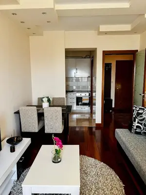 a living room with a couch and a table at Urban Suite Athos in Podgorica
