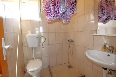 a bathroom with a toilet and a sink at Apartments Stevan in Bar