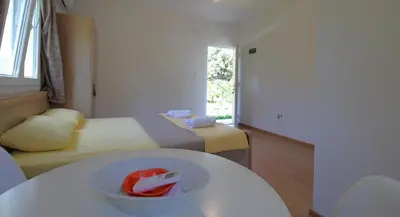 a room with a bowl of fruit on a table at Apartments Stevan in Bar