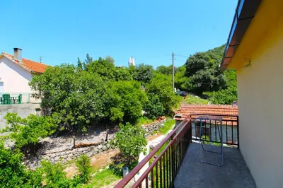 a balcony of a house with trees and bushes at Apartments Stevan in Bar