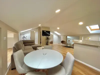 a living room with a white table and chairs at Comfort Apartments Pasha in Budva