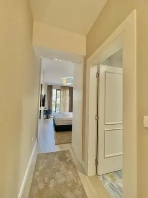a hallway with a door leading to a bedroom at Comfort Apartments Pasha in Budva