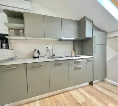 a kitchen with gray cabinets and a sink at Comfort Apartments Pasha in Budva